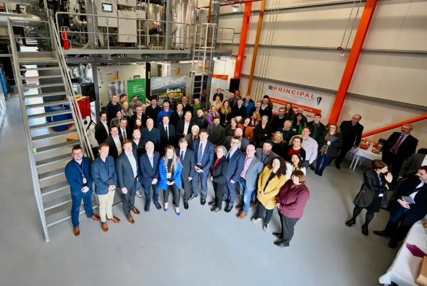 A photo taken from up high of a large group of people standing looking up at the camera at the Tallaght District Heating Scheme