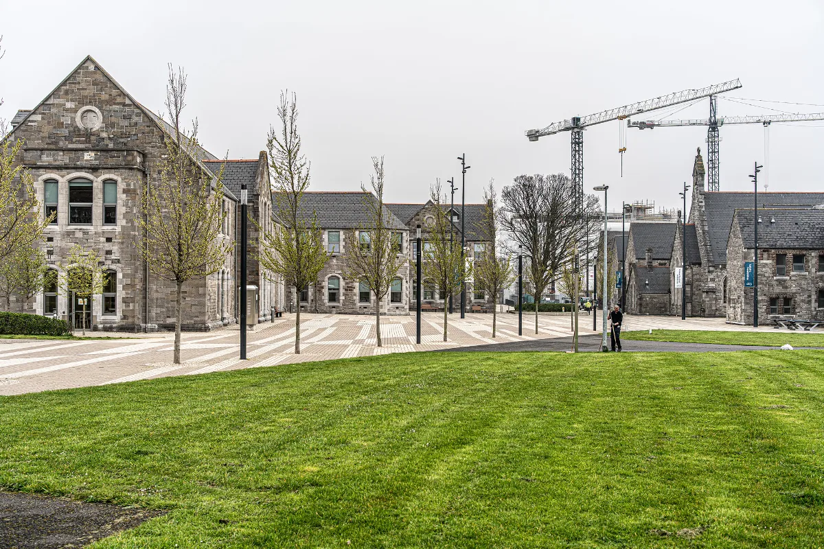 Image of the TU Dublin grangegorman campus with grass in the foreground and old buildings in the background