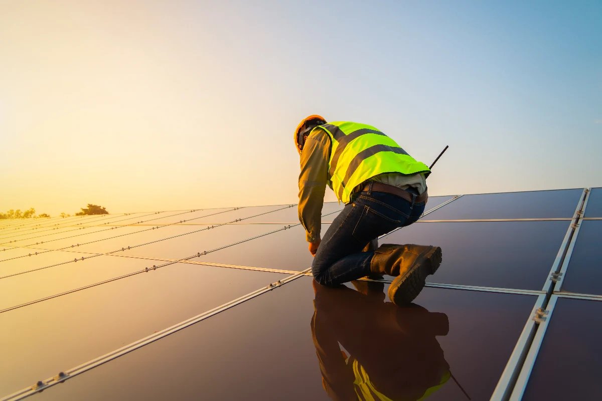 Image of a worker installing solar panels