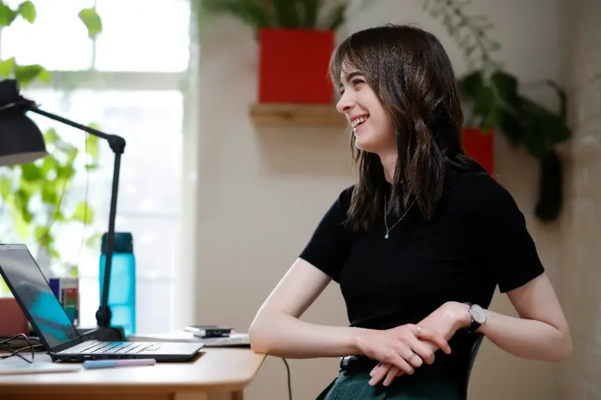 A Codema staff member sits at a desk smiling