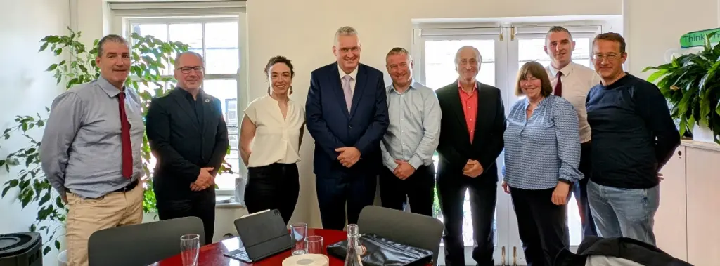 Image of the Codema board, 7 men and two woman smile at the camera