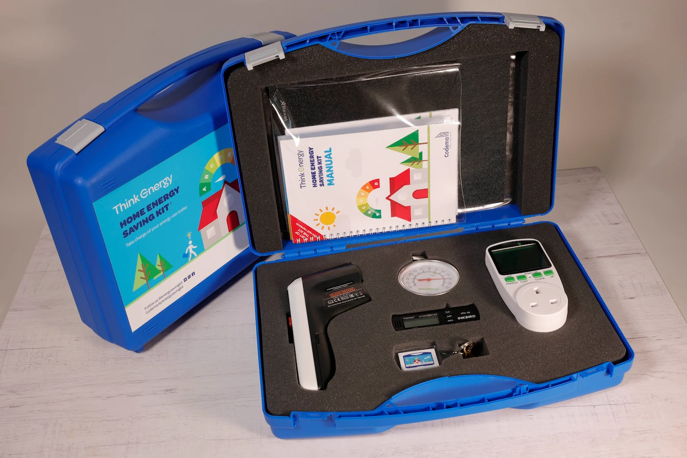 Image of the inside of a home energy saving kit showing tools like the thermal leak detector, fridge thermometre, radiator key, hygrometre and plug-in energy monitor