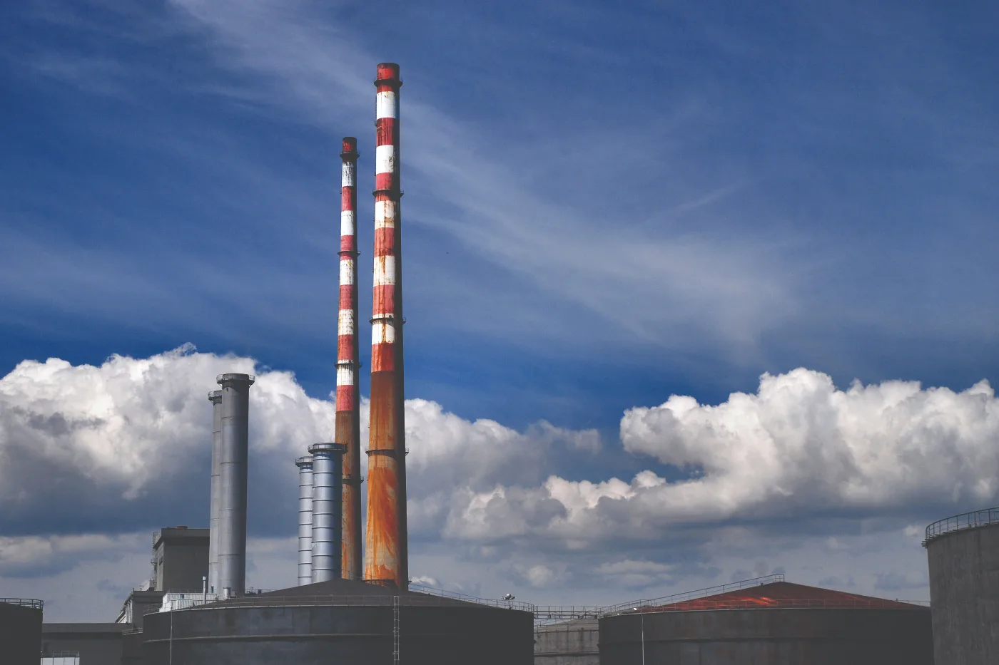 Image of the Poolbeg Towers in Dublin against a blue sky with some clouds