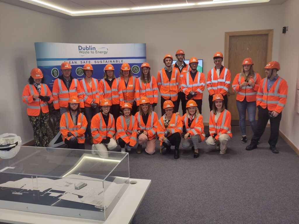 Image of a large group wearing orange high-vis jackets and hard hats at the Dublin Waste to Energy Plant