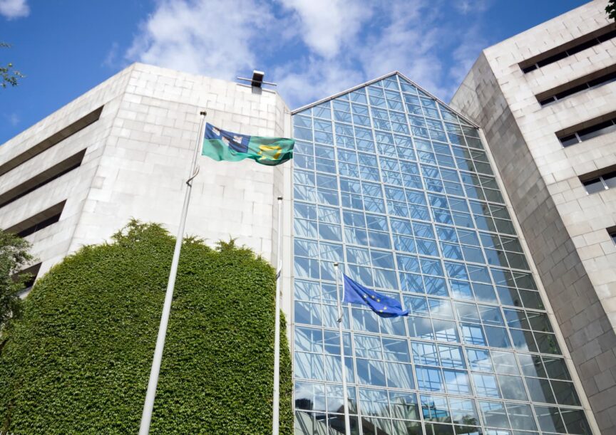 Image of the Dublin City Council building with glass windows and a Dublin and EU flag