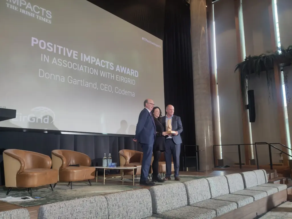 Picture of Codema CEO Donna Gartland being presented the Positive Impacts Award.